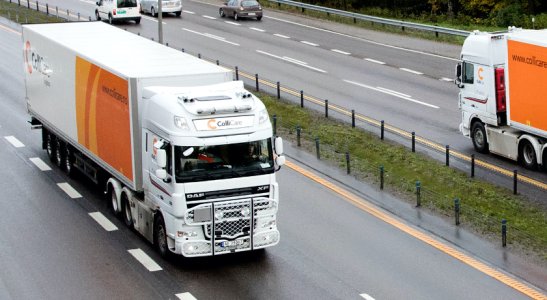 Branded ColliCare trailers passing each other on the freeway in Norway, delivering predictable goods 